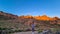 Woman with scenic view on rock formations during sunrise near volcano Pico del Teide, Mount Teide National Park, Tenerife, Spain.