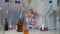 Woman scientist drips reagent into liquid sample above table