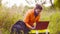 Woman scientist ecologist working on a laptop outdoors