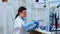 Woman scientist filling liquid test tube with pipette