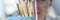 Woman scientist holding test tubes with multicolored liquids in her hands closeup