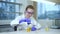 Woman scientist in the laboratory mixing chemical substances yellow liquid in beaker Spbd.