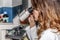 A woman scientist studies something under a microscope in a pharmaceutical laboratory