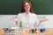 Woman scientist with test tubes and flasks on the table. Conducting scientific research in the student laboratory