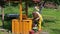 Woman scoop water from rural yellow painted well in bucket