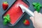 Woman scooping strawberry sorbet out of tray