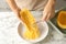 Woman scraping flesh of cooked spaghetti squash with fork