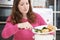 Woman Scraping Food Leftovers Into Garbage Bin