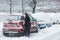 Woman scraping frozen snow from her car windows