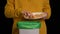 Woman scraping with a plate a pizza into garbage bin
