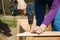 Woman screwing wooden frame for a raised garden bed