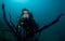 Woman scuba diver swimming in clear blue water