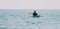 Woman sea kayak. Happy smiling woman in kayak on ocean, paddling with wooden oar. Calm sea water and horizon in