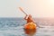 Woman sea kayak. Happy smiling woman paddling in kayak on ocean. Calm sea water and horizon in background. Active