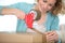 woman sealing cardboard box with tape