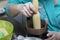 A woman seals a layer of biscuit crumbs in the form of a cake. Cooking a cake of biscuit crumbs and milk jelly. On the surface of