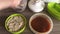 A woman seals a mixture of honey, chopped peanuts and seeds in a container. For shaping halva.