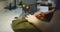 Woman seamstress working on an industrial sewing machine.