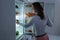 Woman Searching For Food In The Fridge