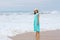 Woman at the seashore of Indian ocean on a cloudy day