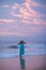 Woman at the seashore of Indian ocean after sunset