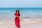 Woman by the seaside wearing red dress