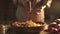 Woman seasoning mixed vegetables in a bowl