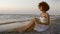 Woman seat on the beach and reading a book