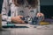 Woman is seen using a punch tool or hole maker. Craft or crafty woman using a hole tool to make holes in rubber material