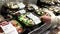 Woman selecting Greek salad inside Costco store