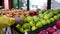 Woman selecting green apple in grocery store