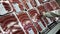 Woman selecting honey garlic sausages inside Costco store