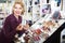 Woman selecting lipstick in store