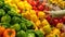 Woman selecting yellow peppers in grocery store