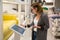 Woman with self-service device in the store