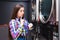 Woman in the self serviece launderette looks at the clock