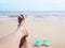 Woman selfie barefoot and blue sunglasses on the beach