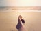 Woman selfie barefoot sunbathing on sunset summer beach