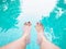 Woman selfie barefoot in the water at swimming pool