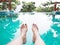 Woman selfie barefoot in the water at swimming pool