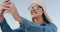 Woman, selfie and outdoor with glasses, kiss and excited with post, web blog and wind by sky background. Gen Z girl