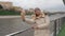 Woman Selfie On Smartphone Standing On The Embankment Of River And City Views