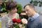 Woman seller helping to pick floral bouquet flowers