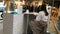 Woman seller sitting behind the counter with goods in a supermarket.