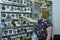 Woman seller standing in front of stand with made in Ukraine chevrons and souveniers. Military shop.