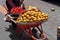 Woman selling Achiote fruits in the streets of Otavalo, Ecuador