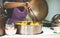 Woman selling boiled corns in pot from cart. Street market.