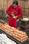 Woman selling eggs at traditional asian food marketplace