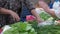 Woman selling fresh vegetables at farmers market.