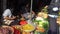 Woman selling tofu, spices and vegetables at the traditional market in the morning. The